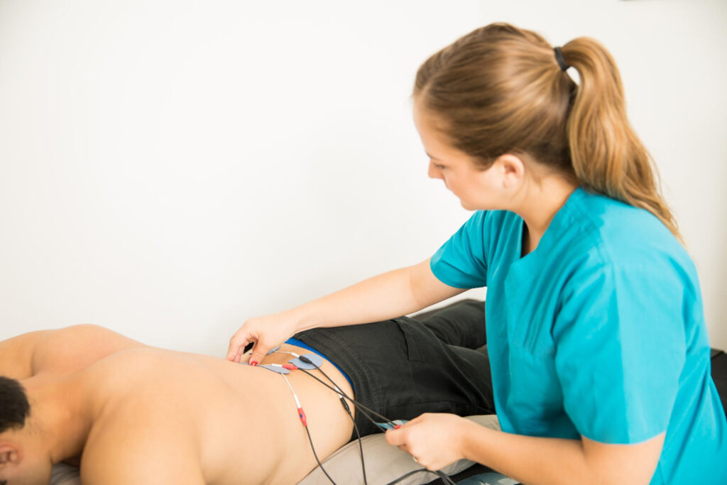 electric muscle therapy on patient's back